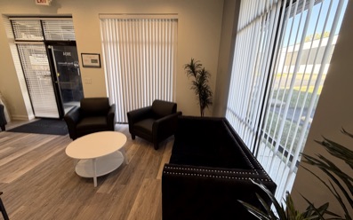 The lounge at our South County clinic, by the front windows, with the front door and its number at the back.