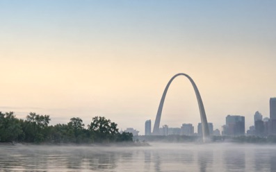 The Gateway Arch above the Mississippi at dawn.